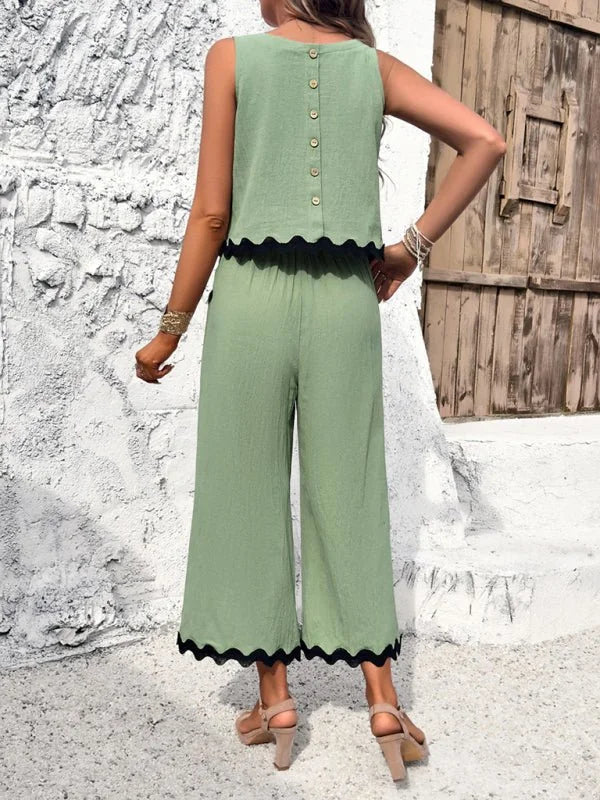 Light green viscose wide-leg pant suit with scalloped trim on top and pants, shown from the back on a model.