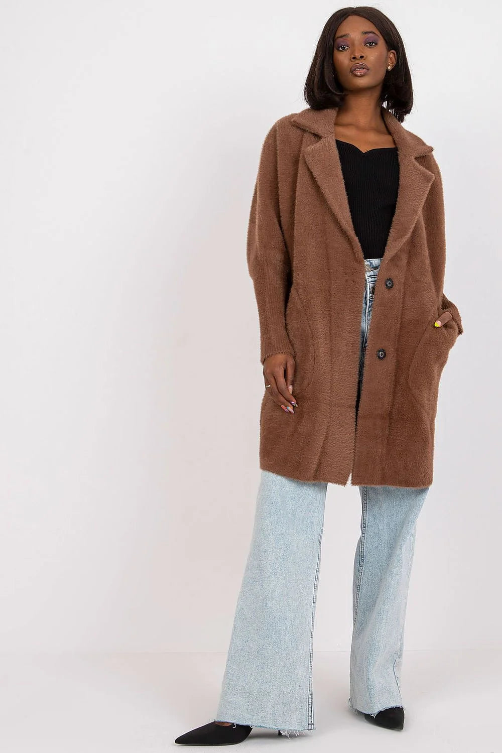 Brown fuzzy long coat with button closure and wide-leg jeans on model