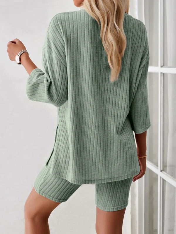 Soft sage green ribbed knit short suit with a relaxed fit top and bike shorts.