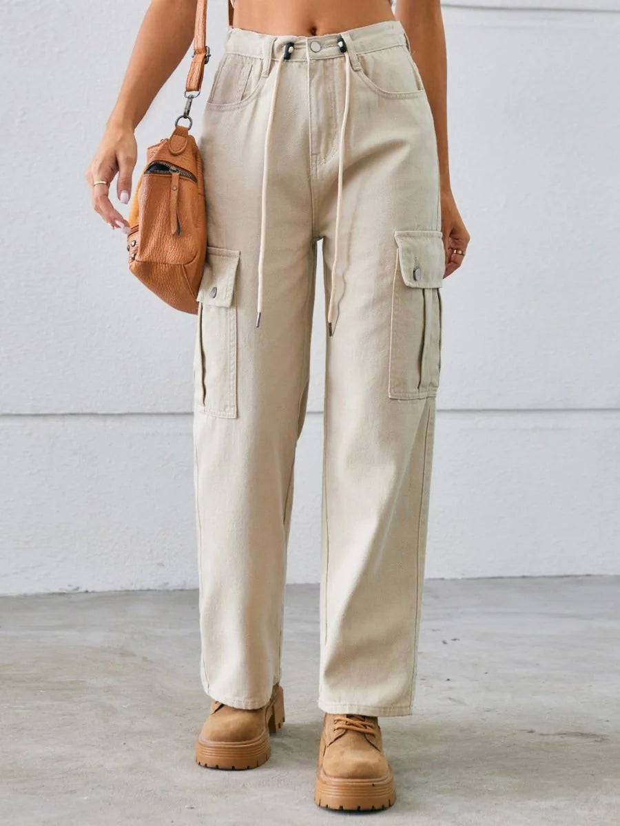 Beige cargo pants with drawstring waist, side pockets, and chunky platform shoes.