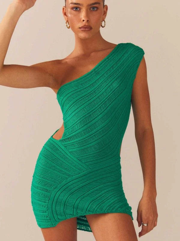 Emerald green one-shoulder knit mini dress with cut-out detail and textured ribbed pattern on model.