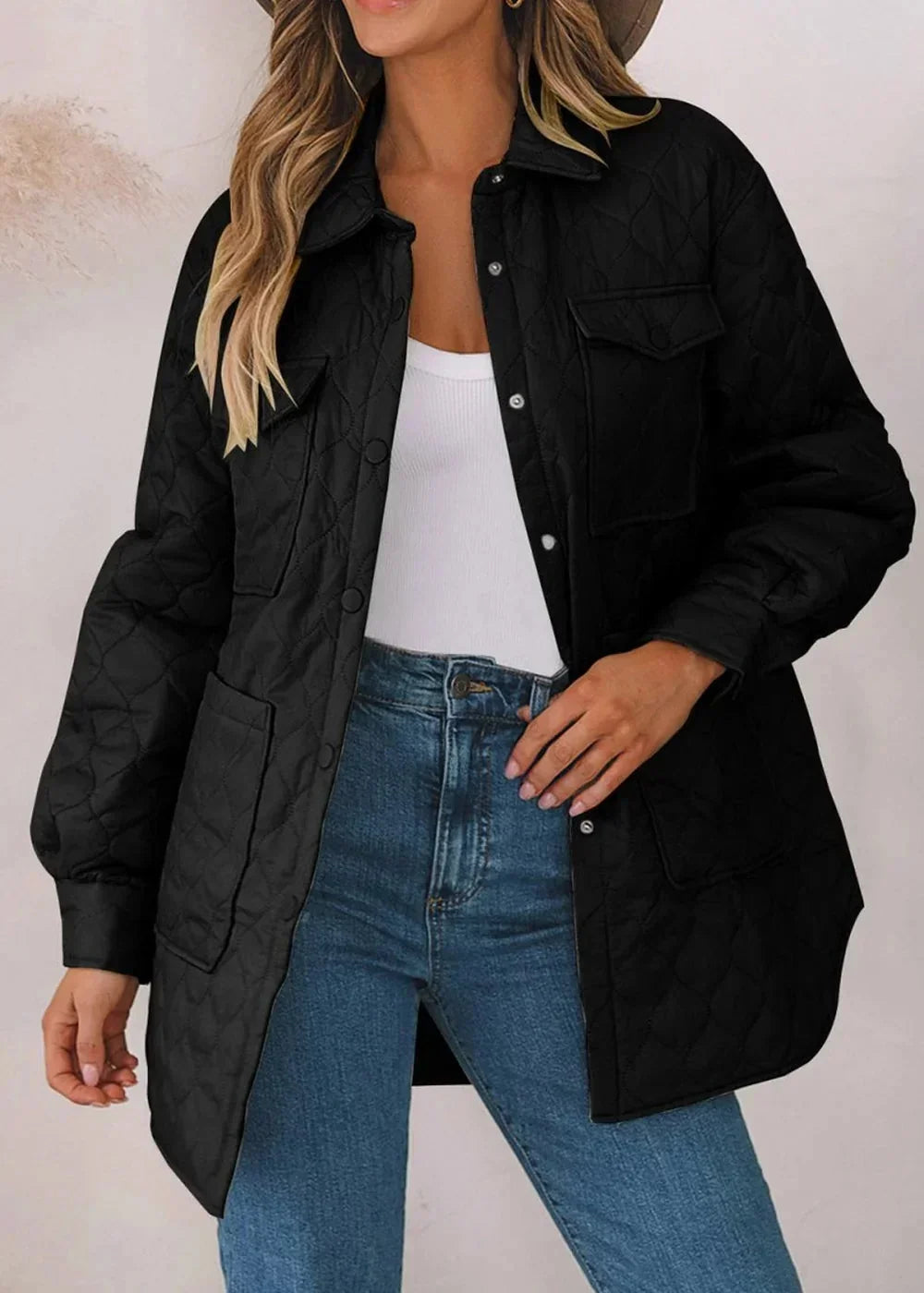 Black quilted nylon jacket with snap buttons and chest pockets on a model.