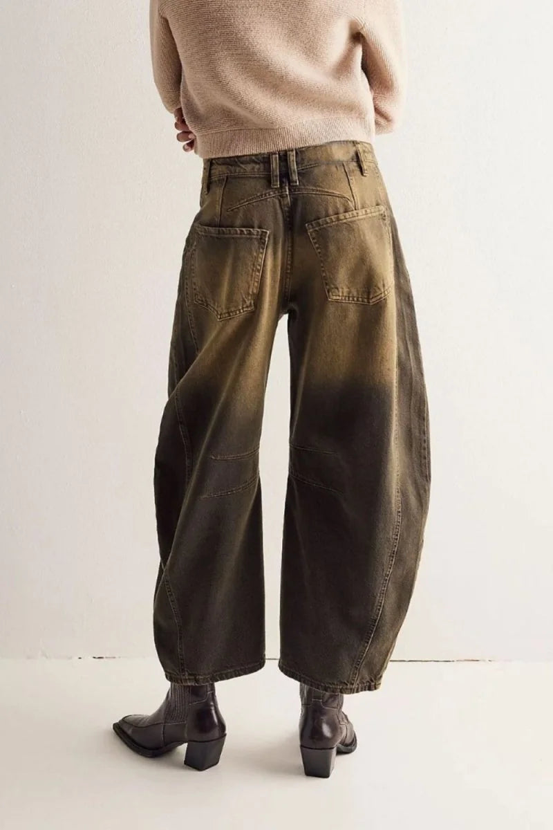 Back view of relaxed fit, wide-leg, olive-green denim pants with a faded ombre effect.