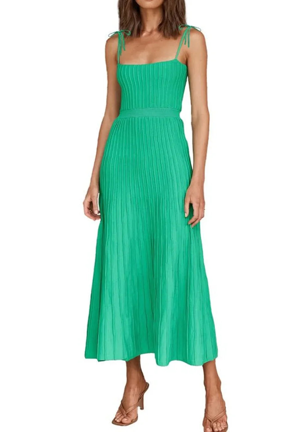 Green ribbed knit midi dress with tie straps, fitted bodice, and pleated skirt, worn by a model.