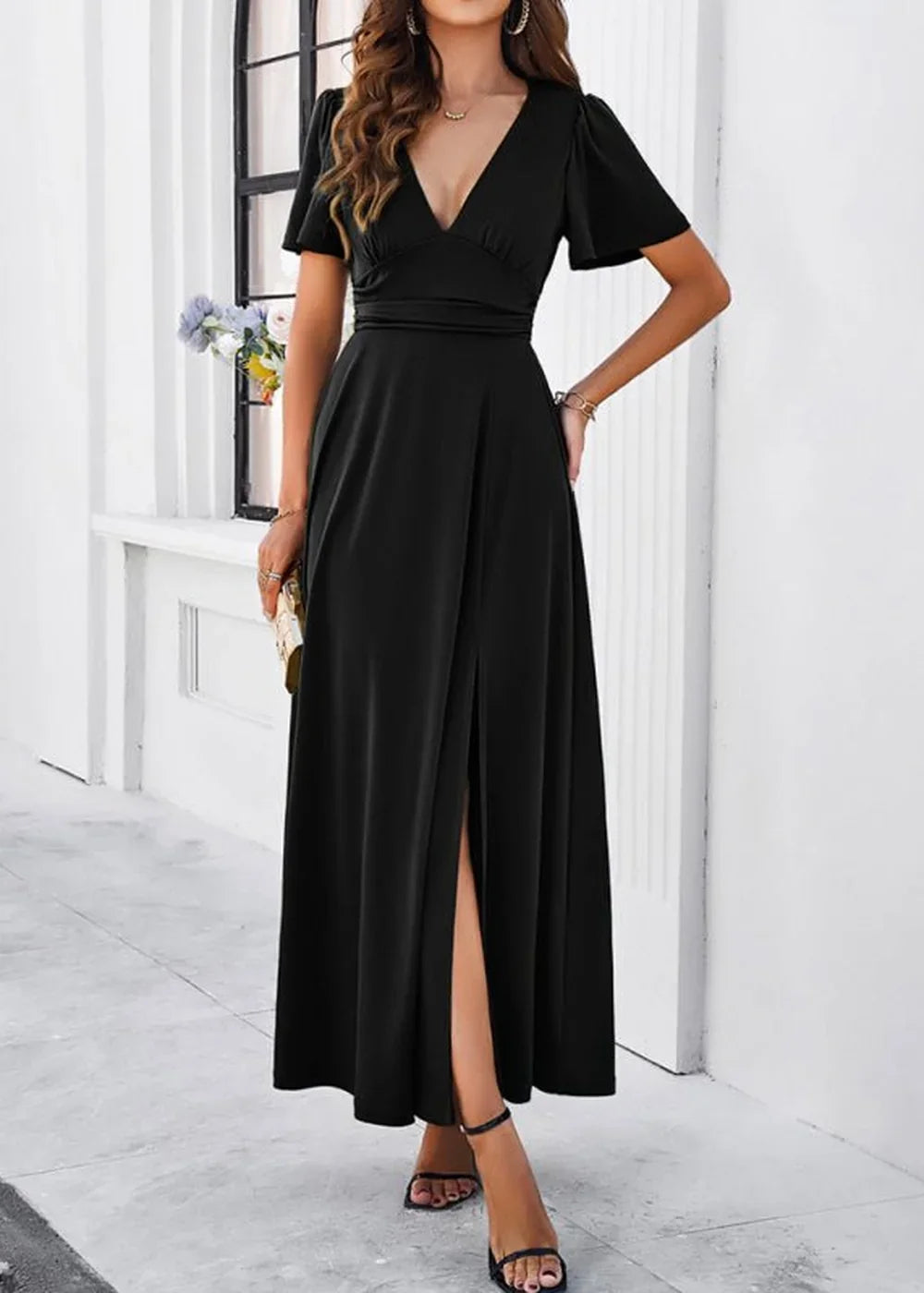 Black V-neck maxi dress with flutter sleeves and a thigh-high slit.