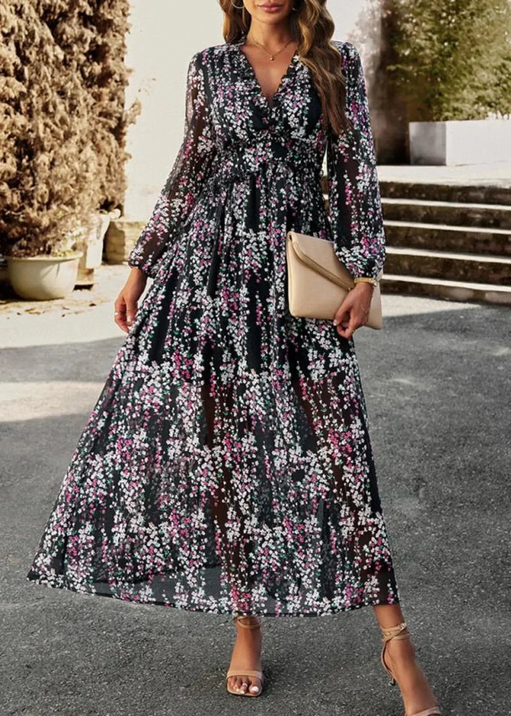Black floral maxi dress with V-neck, long sleeves, cinched waist, and flowing skirt.