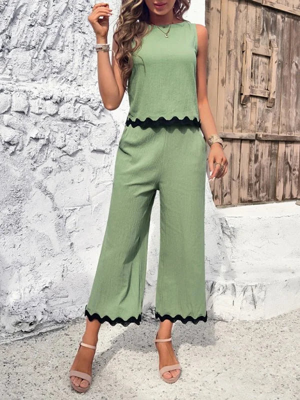Light green viscose wide-leg pant suit with black scalloped trim on top and pants.
