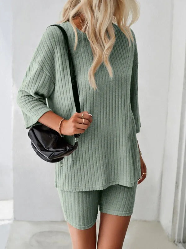 Sage green ribbed knit lounge set with a relaxed fit top and bike shorts, worn by a model.