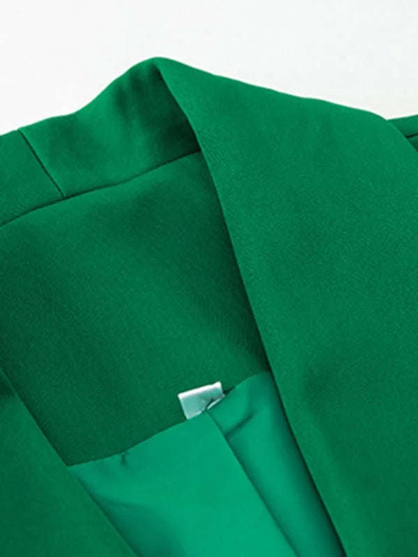 Close-up of a vibrant green blazer collar and lapel, showing smooth fabric texture.