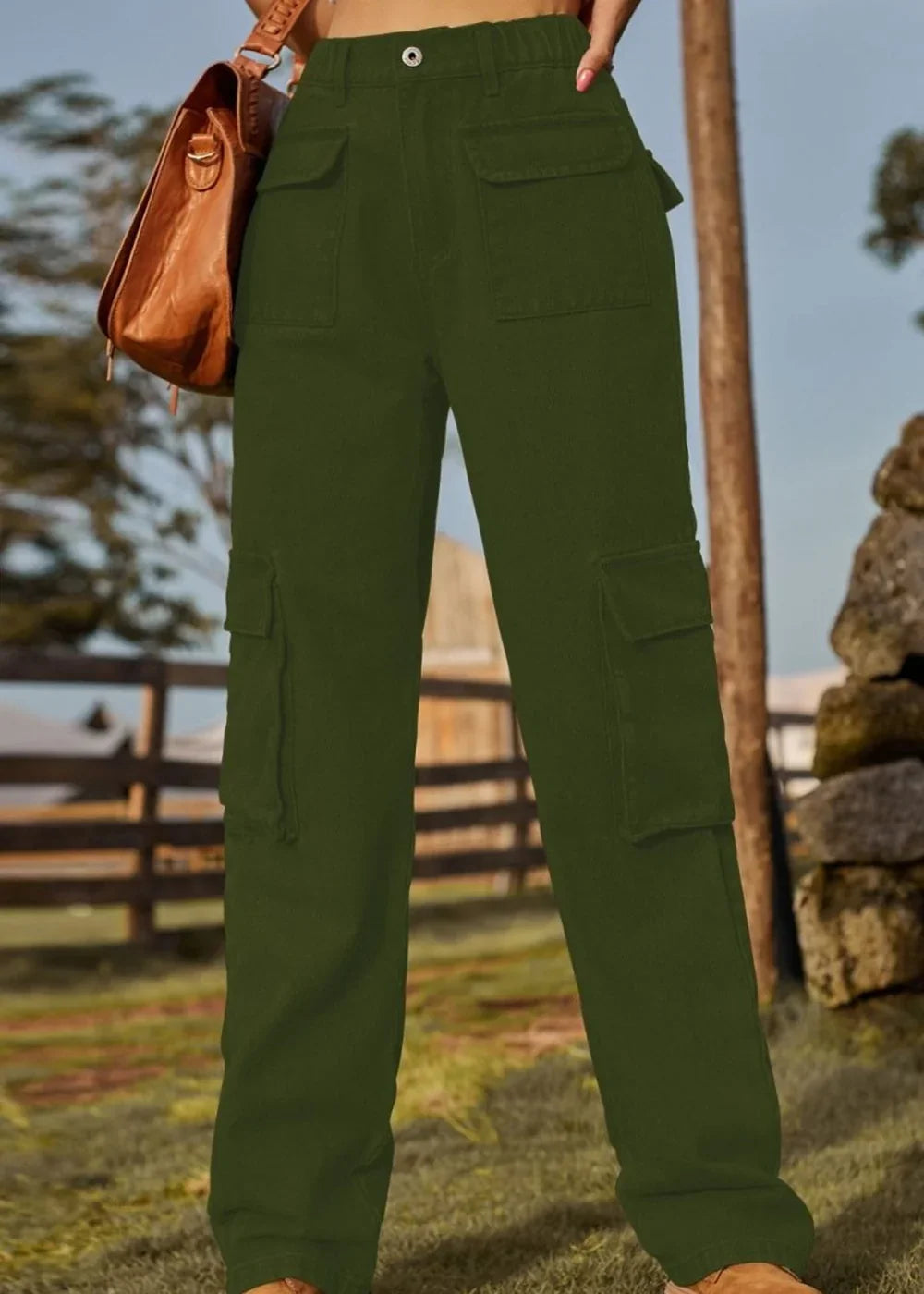 Women's olive green cargo pants with large front and side pockets, full length on model.