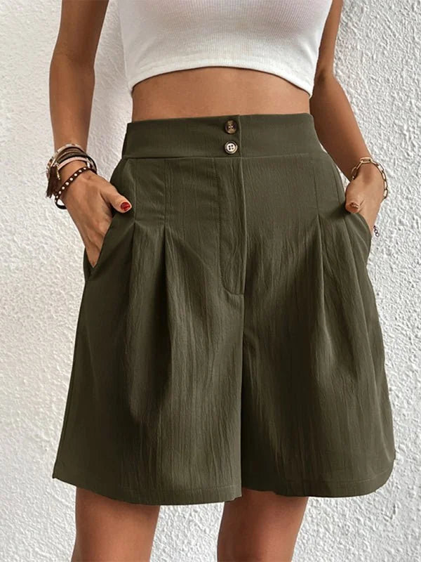 Khaki green textured shorts with a high waist and two button closure, on model.