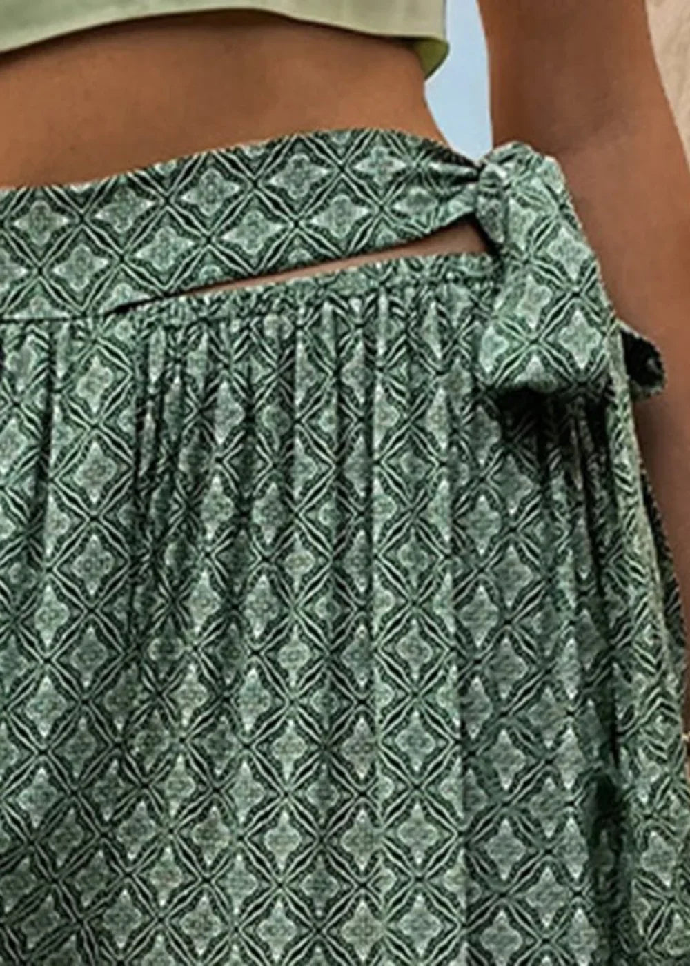 Green rayon skirt with a geometric print and tie-waist detail.