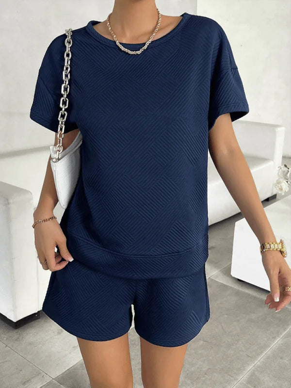 Navy blue textured short suit with crew neck top and shorts, worn by a model.