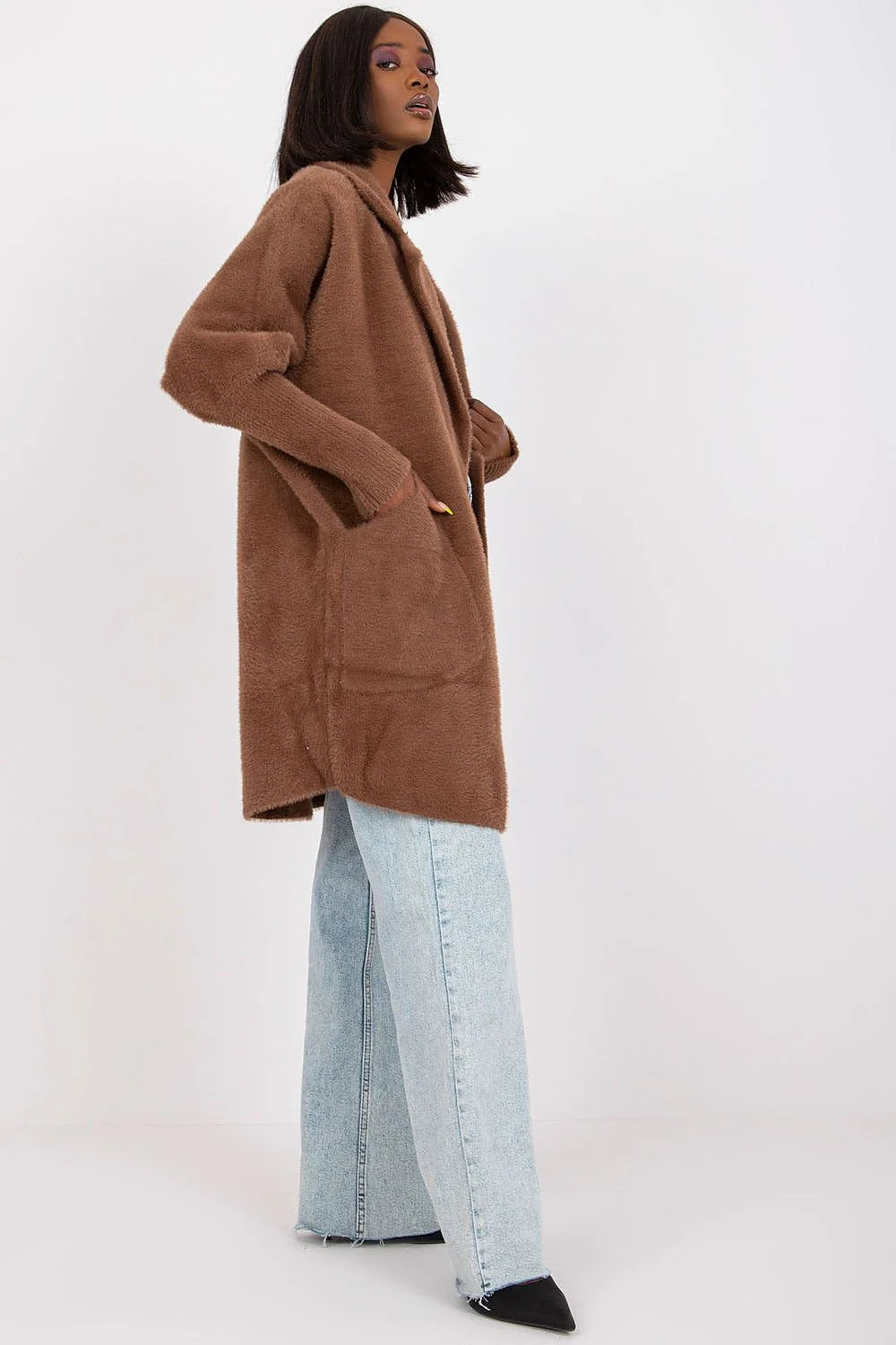 Brown fuzzy longline cardigan with pockets, worn by a model with light wash wide-leg jeans.
