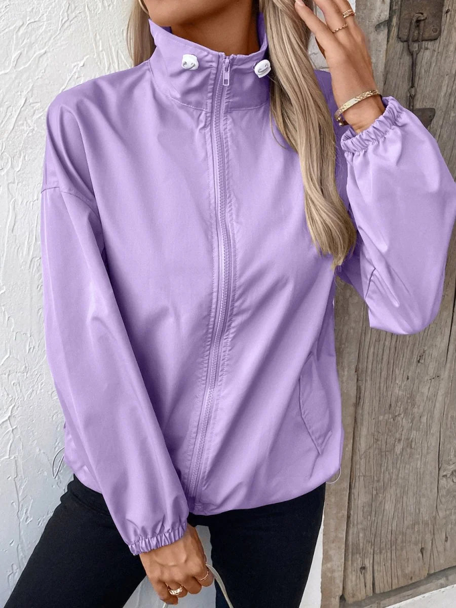 Light purple polyester jacket with full zipper and elastic cuffs, worn by a model.