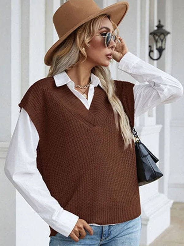 Brown v-neck knit sweater vest over a white collared shirt, worn by a model with a tan hat.