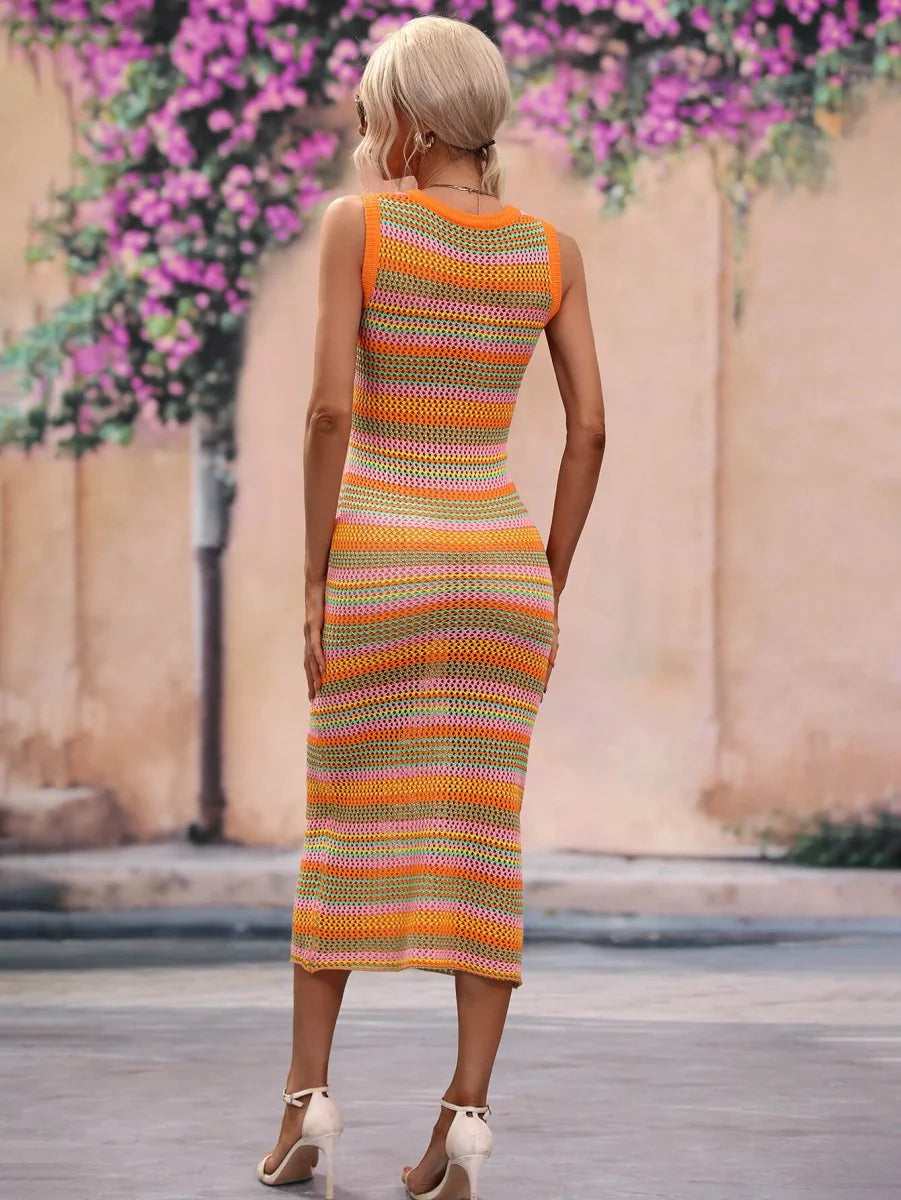 Back view of a woman wearing a sleeveless, striped crochet midi dress in orange, pink, and green.