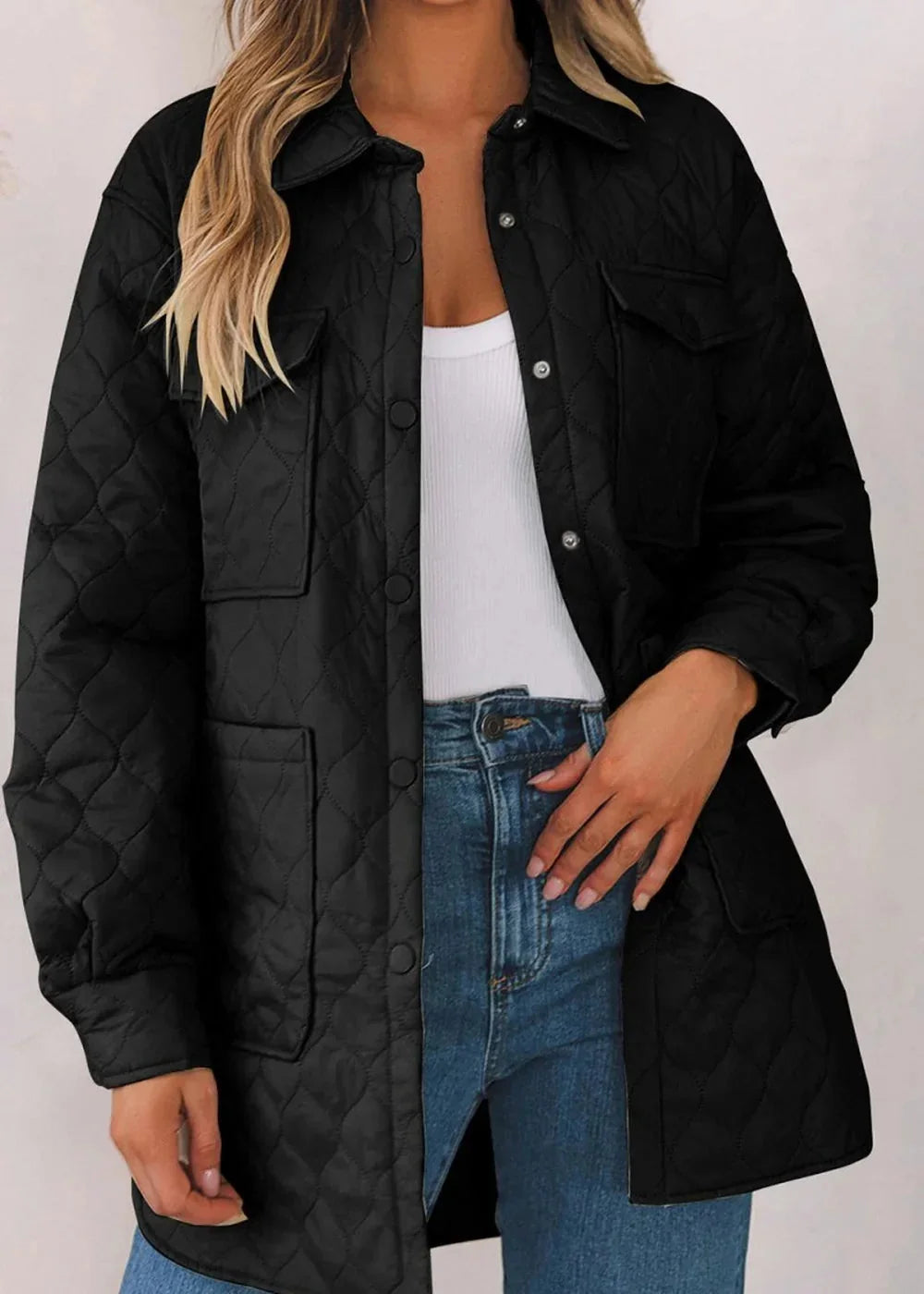 Black quilted jacket with snap closures and chest pockets, worn over a white tank and blue jeans.
