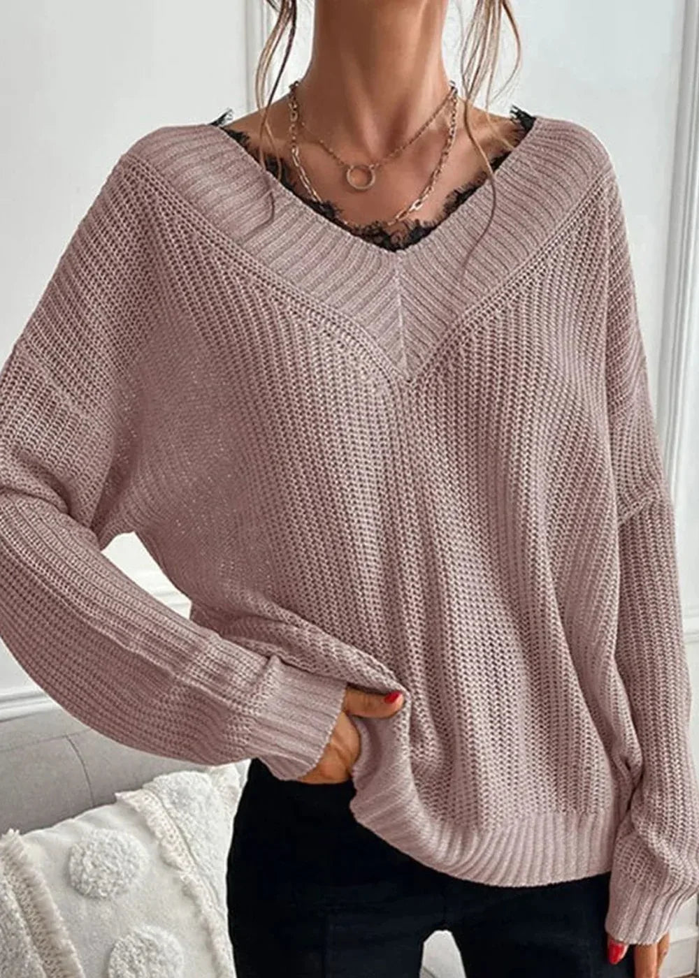 Dusty rose knit sweater with black lace trim and V-neck, worn by a model.