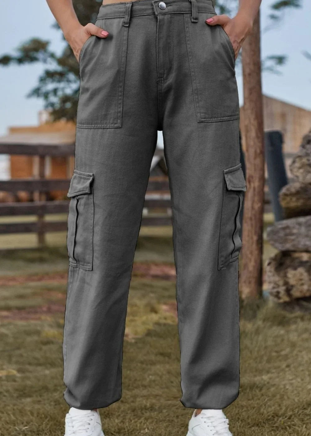 Dark grey cargo pants with multiple pockets and a regular fit, shown on a model.