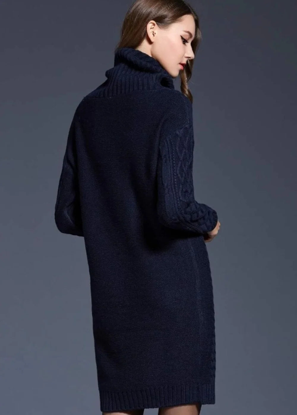 Navy blue chunky knit turtleneck sweater dress with cable knit sleeves, shown from the back.