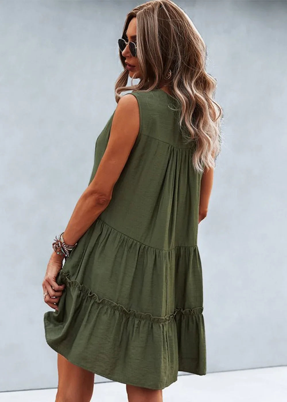 Olive green tiered ruffle dress with a relaxed fit, shown from the back on a model.