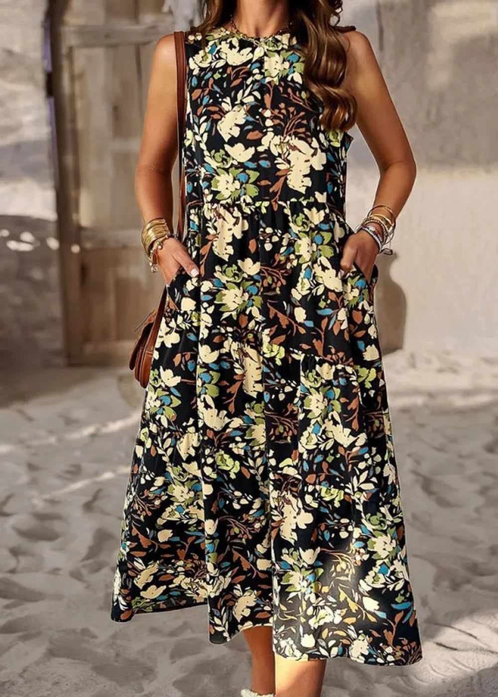 Black floral print midi dress with a tiered skirt and pockets, worn by a model.