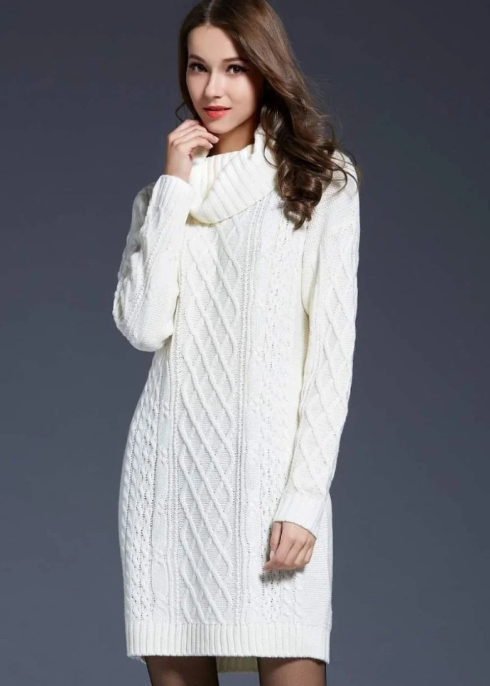 Woman wearing a white cable-knit sweater dress with a cowl neck.
