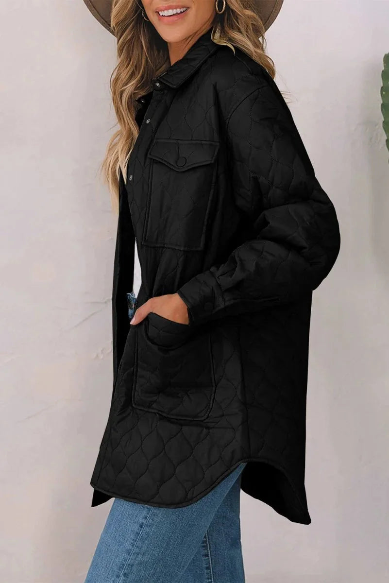 Black quilted shacket with button-flap pockets and a relaxed fit, shown on a model.