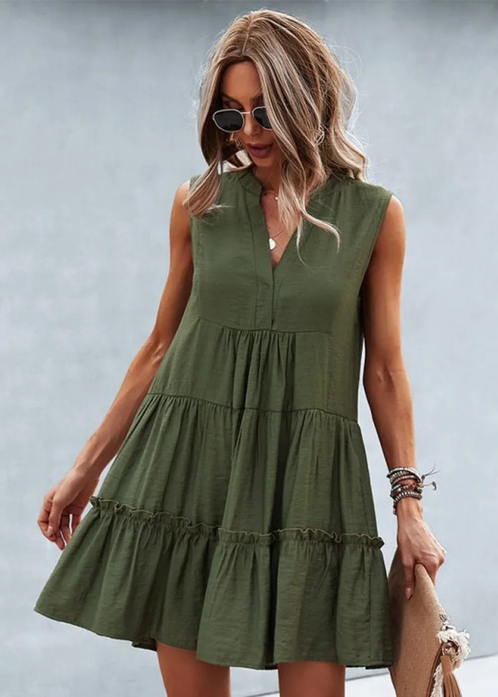 Olive green tiered ruffle sleeveless dress with a V-neck on a model.