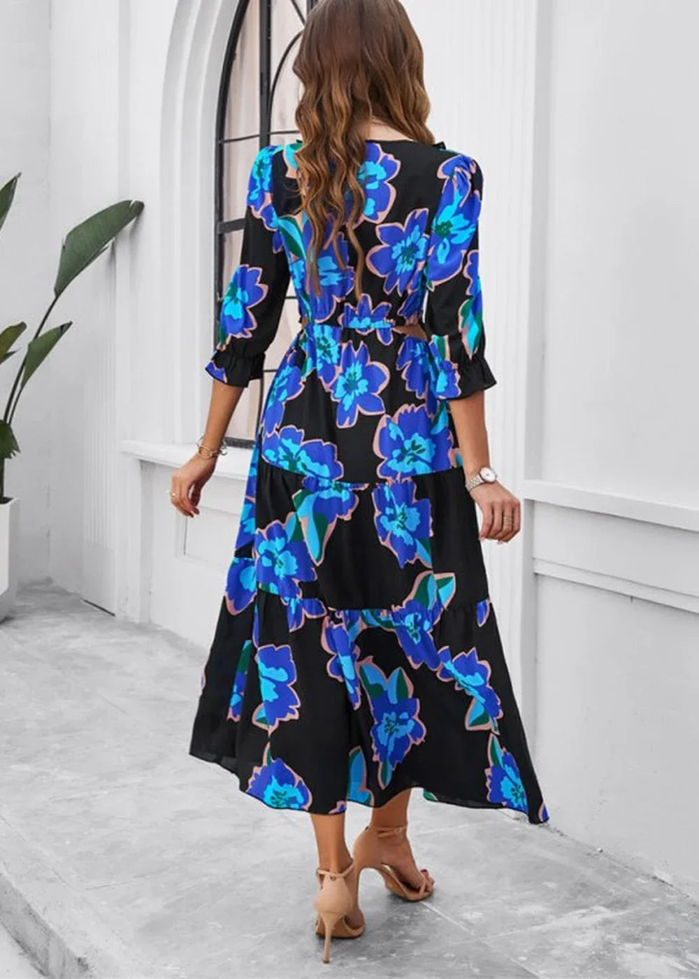 Black maxi dress with a vibrant blue floral print, tiered skirt, and 3/4 sleeves.