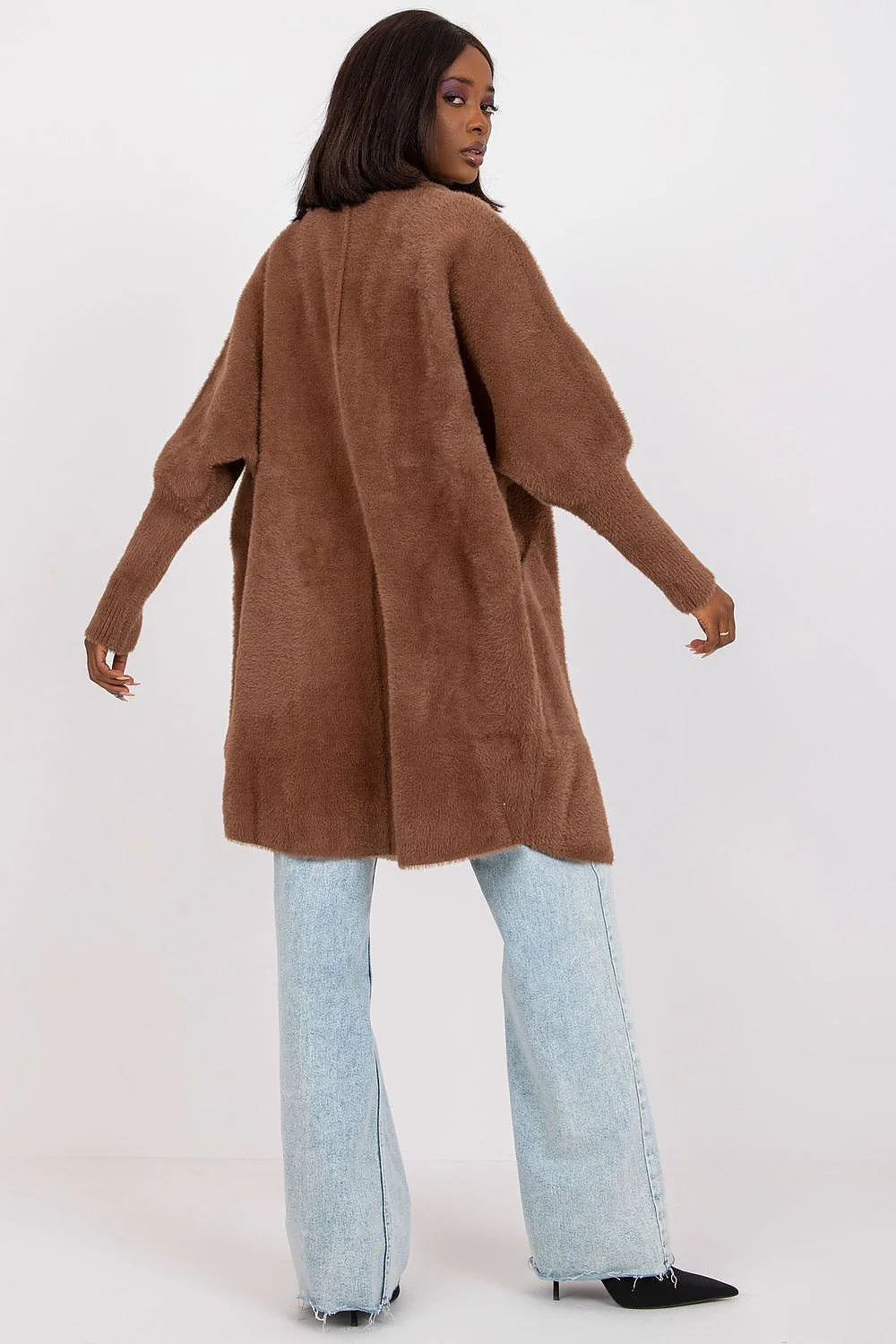 Brown fuzzy oversized cardigan with wide bell sleeves and light wash flared jeans on model.