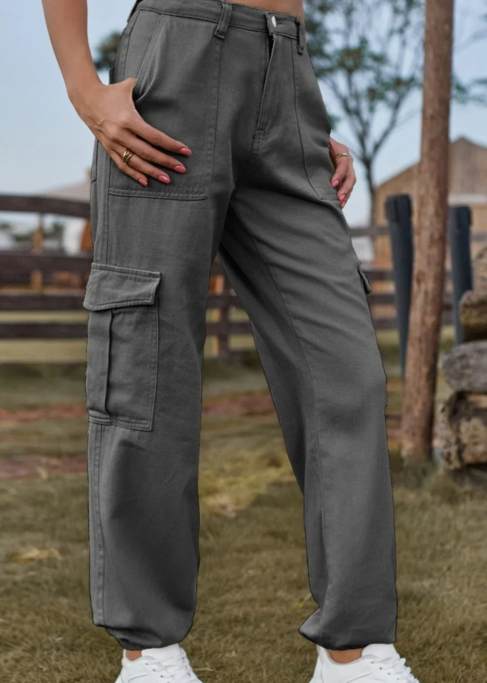 Gray cargo pants with large side pockets, regular fit, on model.