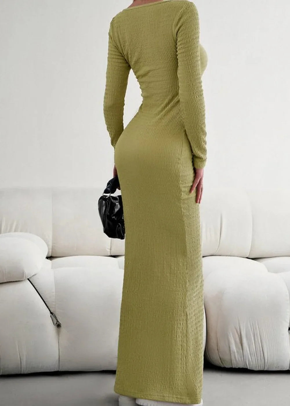 Olive green textured long-sleeve maxi dress with a bodycon fit, held in profile.
