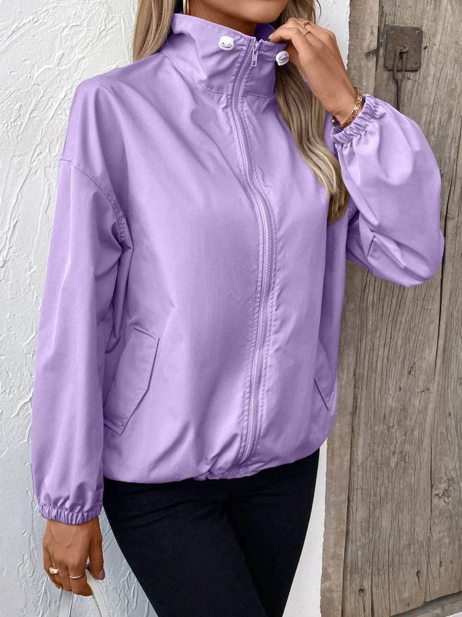 Light purple polyester jacket with a stand-up collar, zip front, and elastic cuffs, worn by a model.