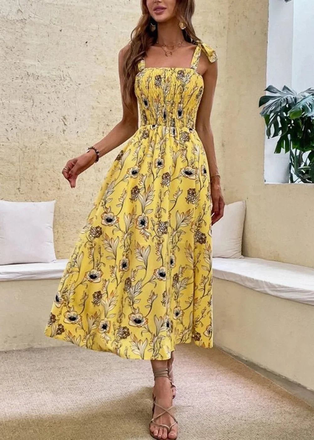 Yellow floral print midi dress with smocked bodice and tie straps.