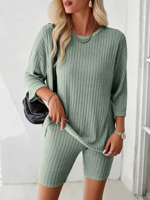 Sage green ribbed knit top and biker shorts set on a model, showing texture and fit.