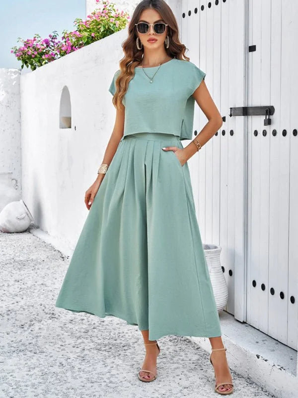 Light sage green viscose crop top and wide-leg pleated skirt suit on model.