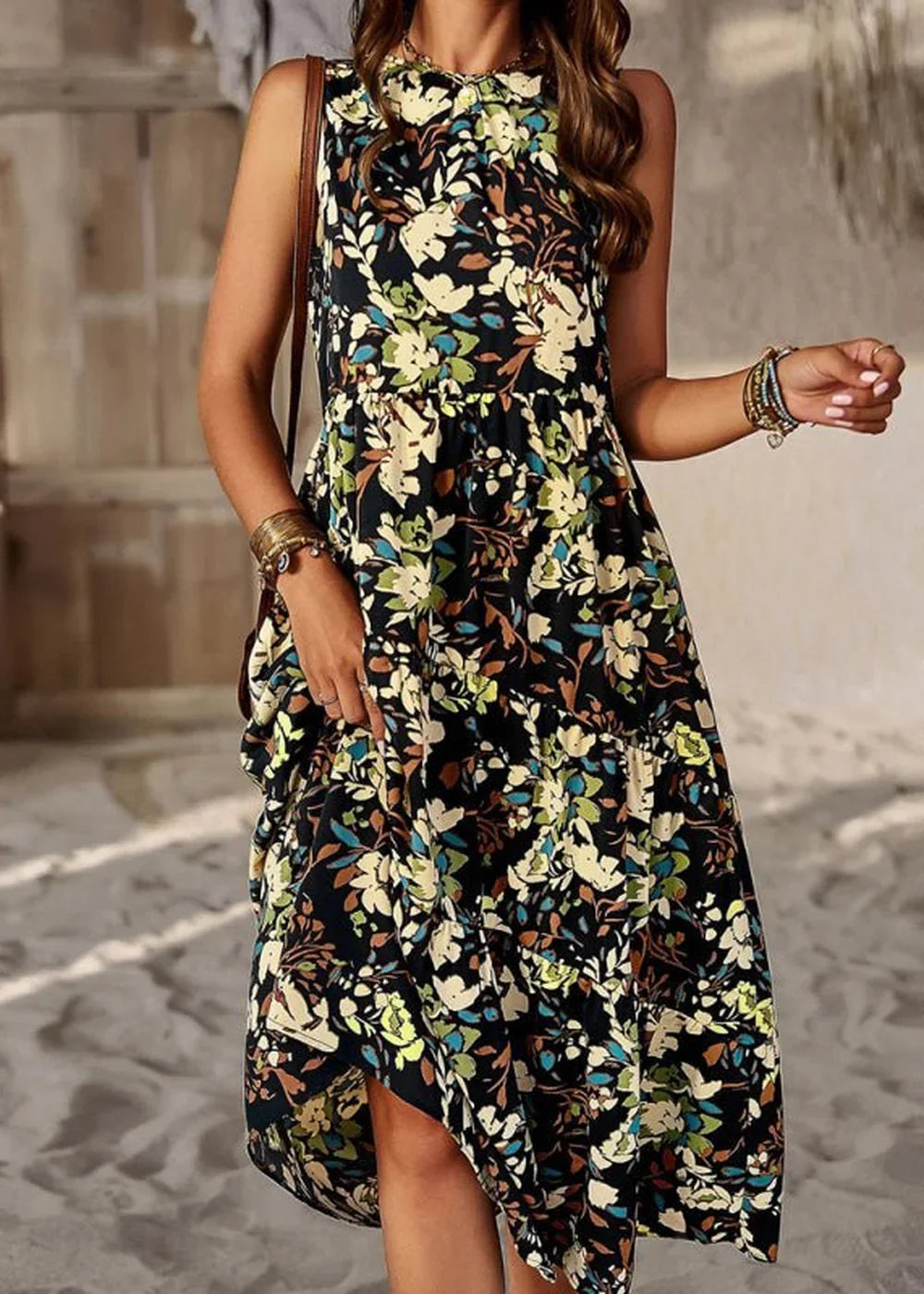 Black floral print dress with a tiered hem and ruffled details, worn by a model.