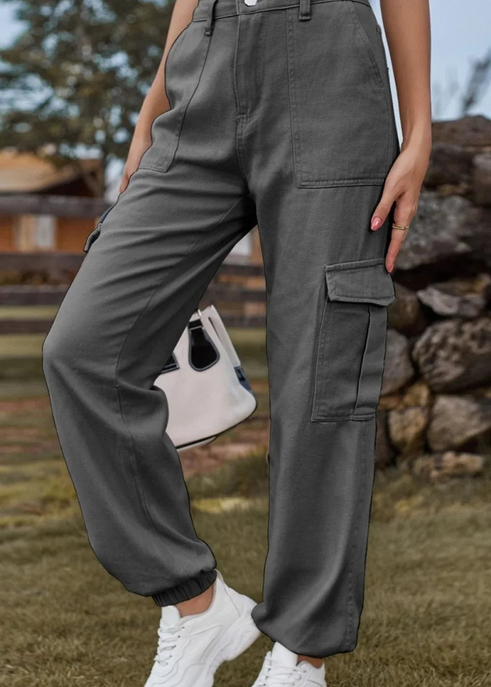 Model wearing dark gray cargo pants with elastic cuffs and white sneakers.