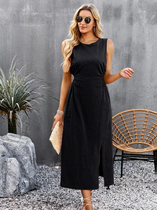 Black sleeveless midi dress with a thigh-high slit and a woven clutch, worn by a model.