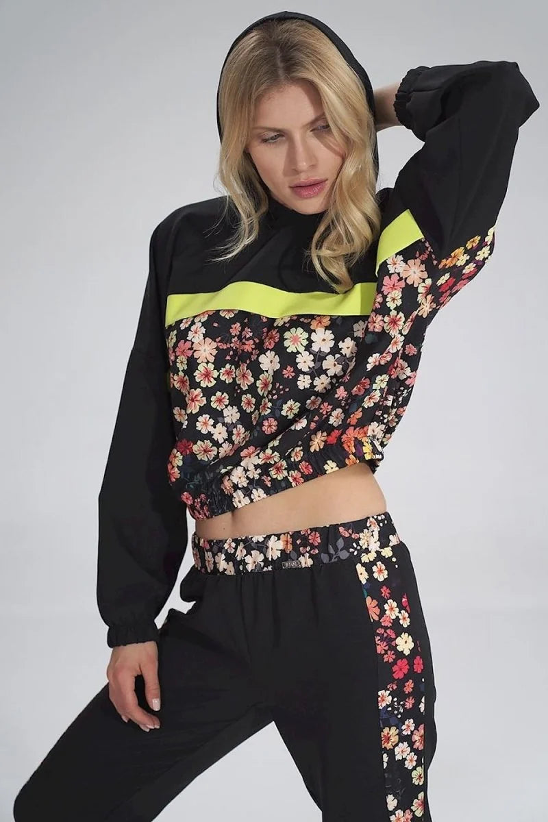 Black hooded sweatshirt with floral panel and neon yellow stripe, paired with matching pants.