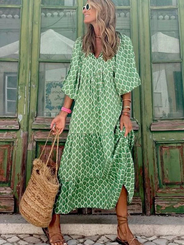 Green geometric print tiered maxi dress with basket bag, on model.