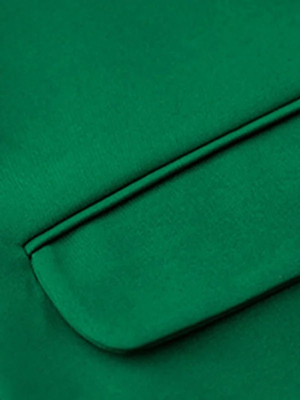 Close-up of a green polyester blazer pocket with a satin trim detail.