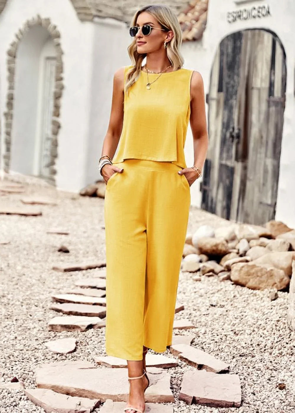 Yellow wide-leg cropped pantsuit with a sleeveless top on a model.