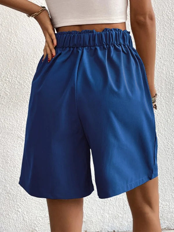 Navy blue shorts with a ruffled elastic waistband and a relaxed fit.