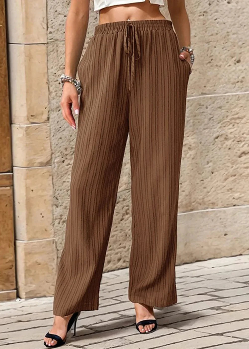 Brown textured wide-leg pants with a drawstring waist.