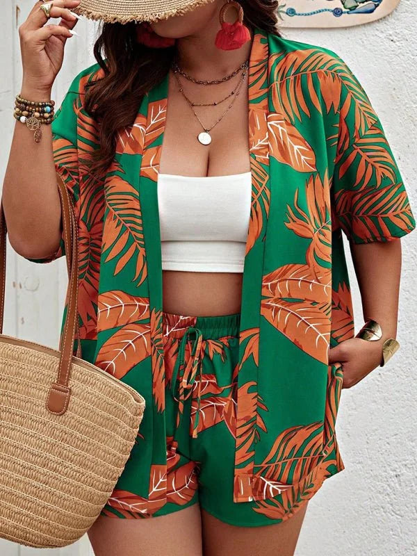Green kimono and shorts set with orange leaf print, white crop top, and straw bag.
