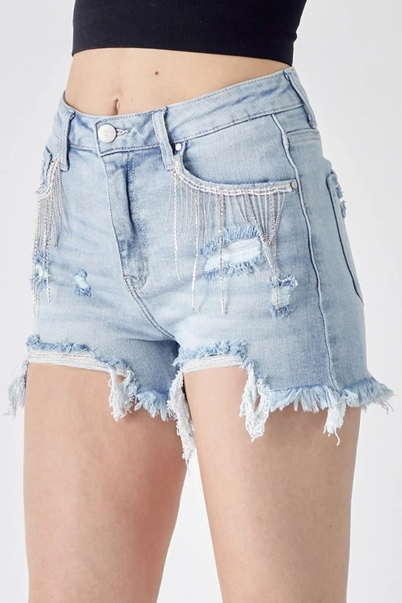 Light wash denim shorts with frayed hem and fringe pockets