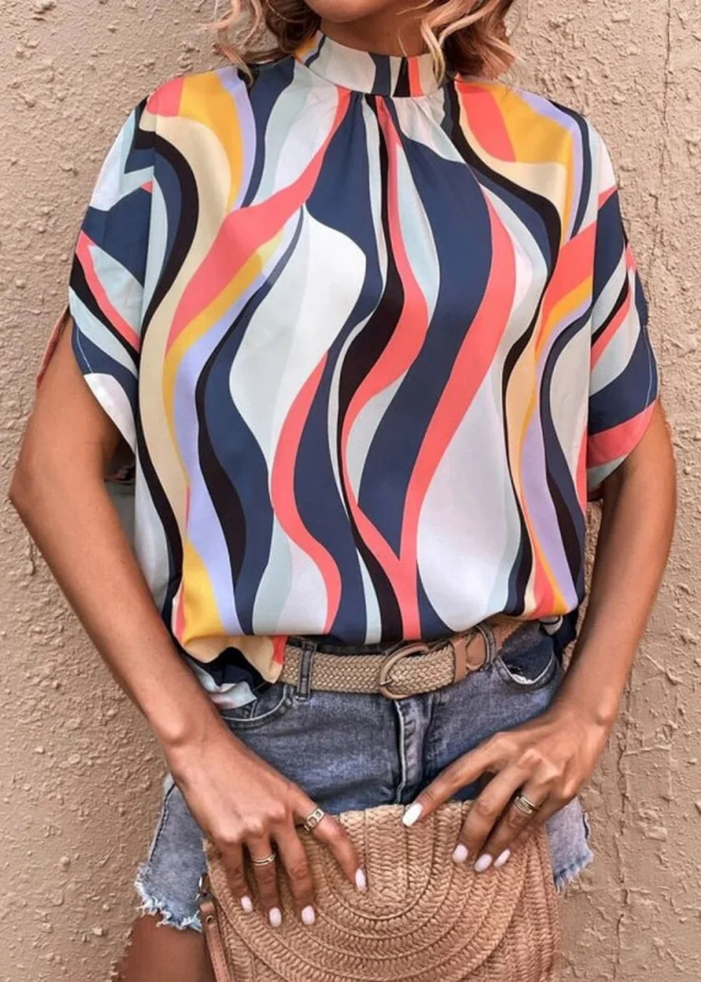 Orange printed dolman sleeve top with black accents